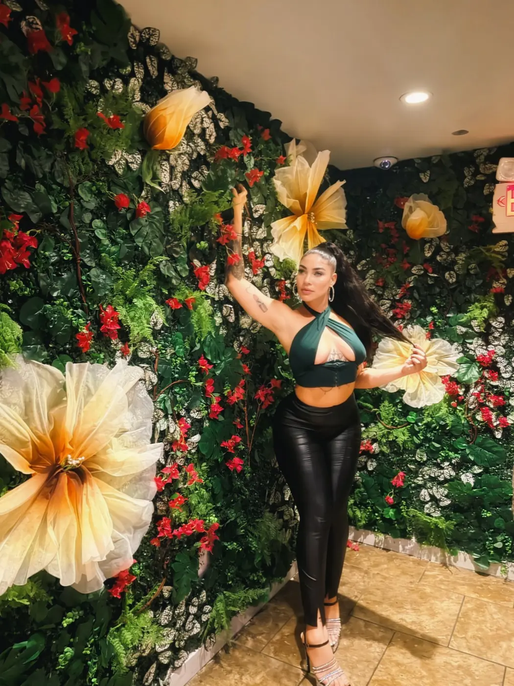 Posing at a flower wall