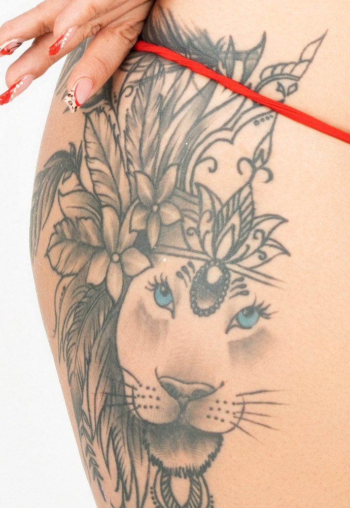Lion tattoo on her thigh